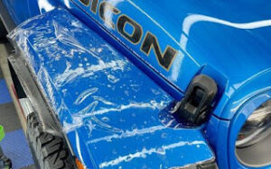 Blue Jeep Rubicon with a clear PPF finish on the fender