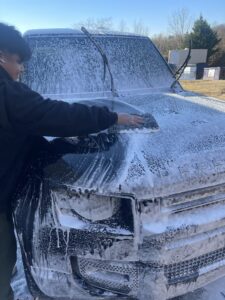 Washing the hood of a Ford truck